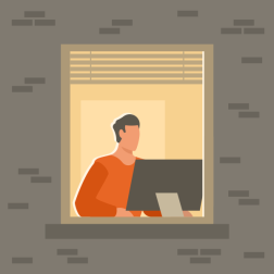 Person working at computer in apartment window